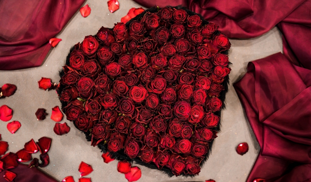 Сердце из красных роз на постели
