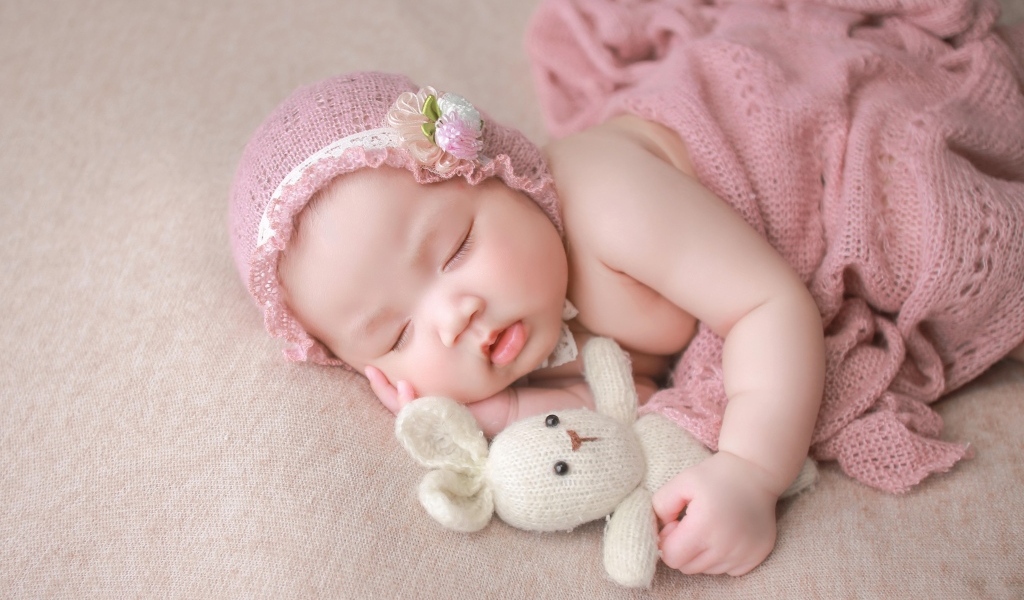 Девочка азиатка спит с игрушечным зайцем