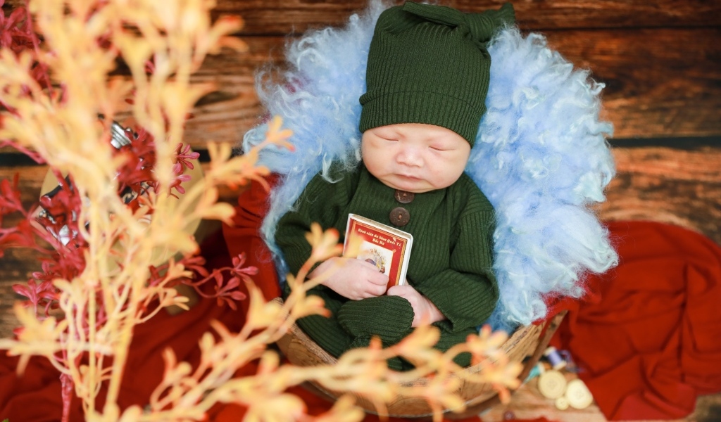 Ребенок спит в костюме с книгой