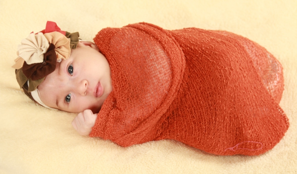 Новорожденная девочка в красном покрывале