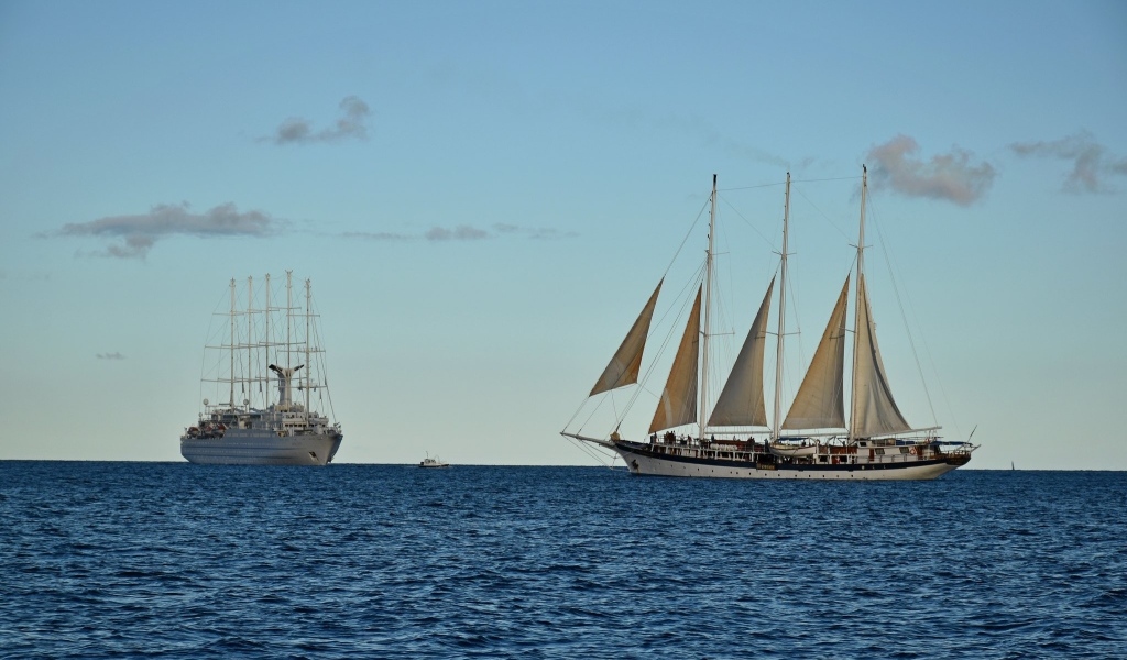 Sailing yacht and ship on the high seas