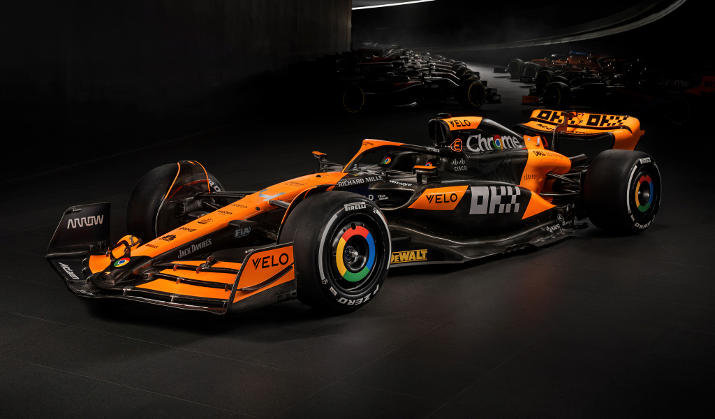 Гоночный автомобиль McLaren MCL38 Formula 1 2024 года на черном фоне
