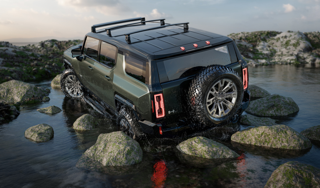 Внедорожник GMC Hummer EV Pickup 2024 года едет по камням