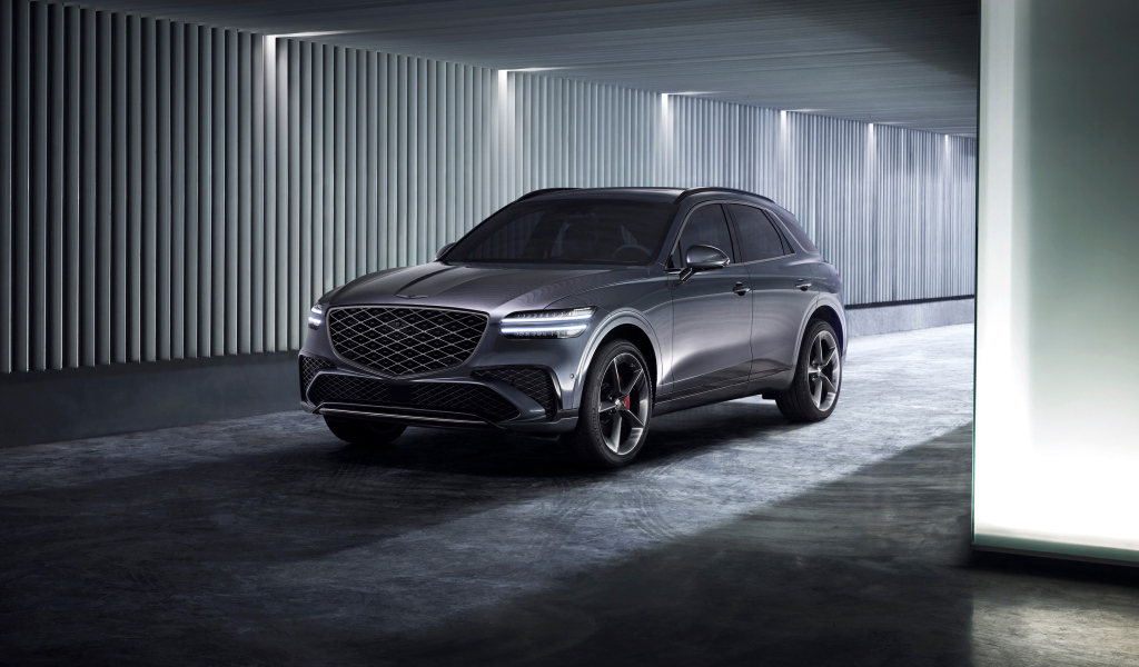 Серебристый автомобиль Genesis GV70 Sport 2024 года