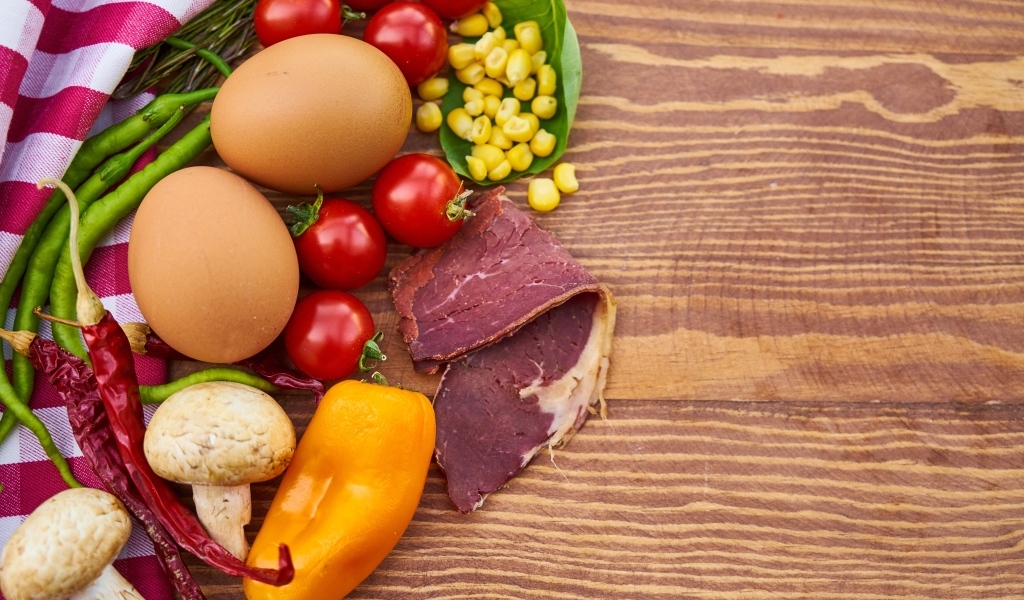 Продукты на деревянном столе с полотенцем