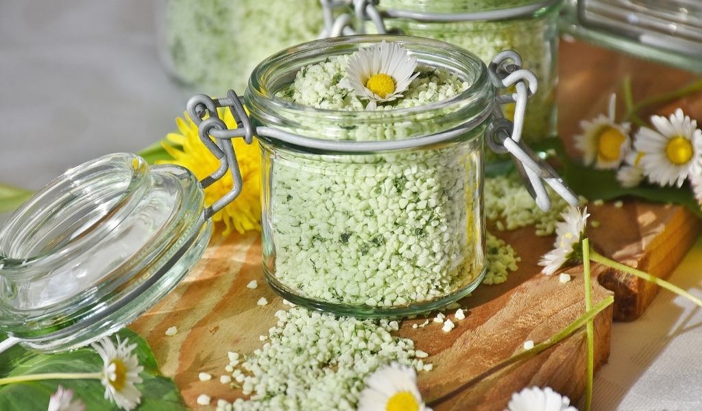 Salt in a jar with chamomile flowers