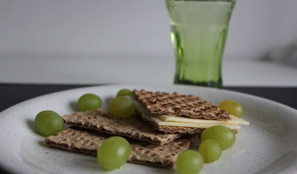 Вафли с сыром и виноградом на тарелке