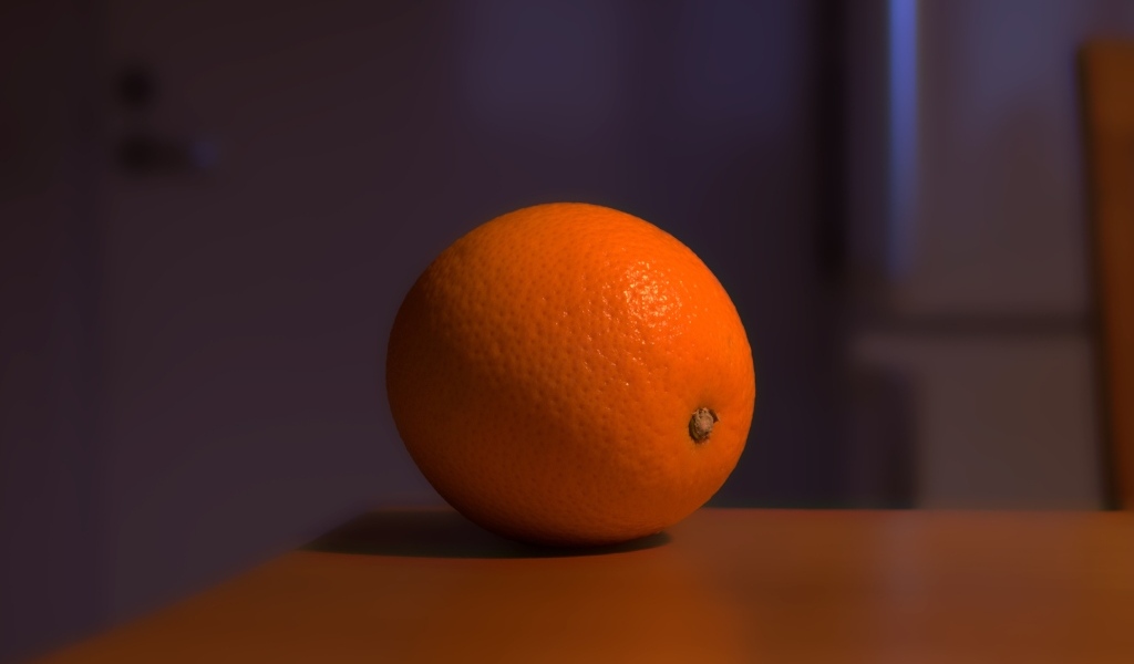 Один оранжевый апельсин лежит на столе