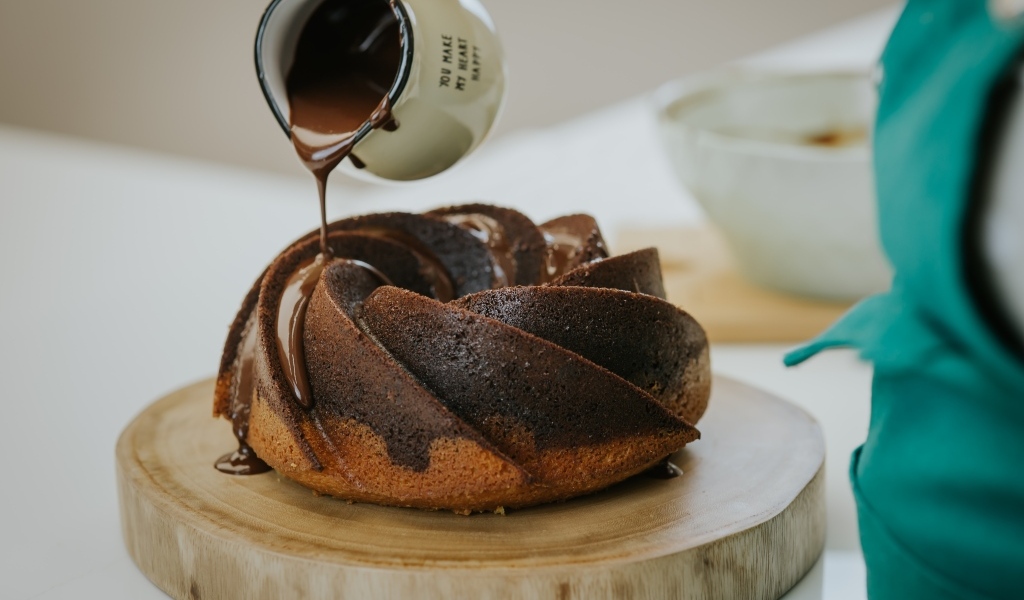 Кекс покрывают растопленным шоколадом