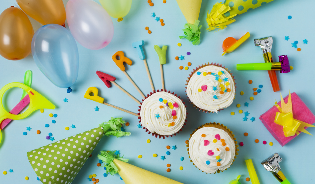 Кексы и праздничный декор на день рождения на голубом фоне