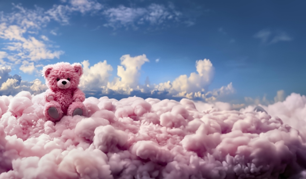 Розовый плюшевый медведь сидит на облаке