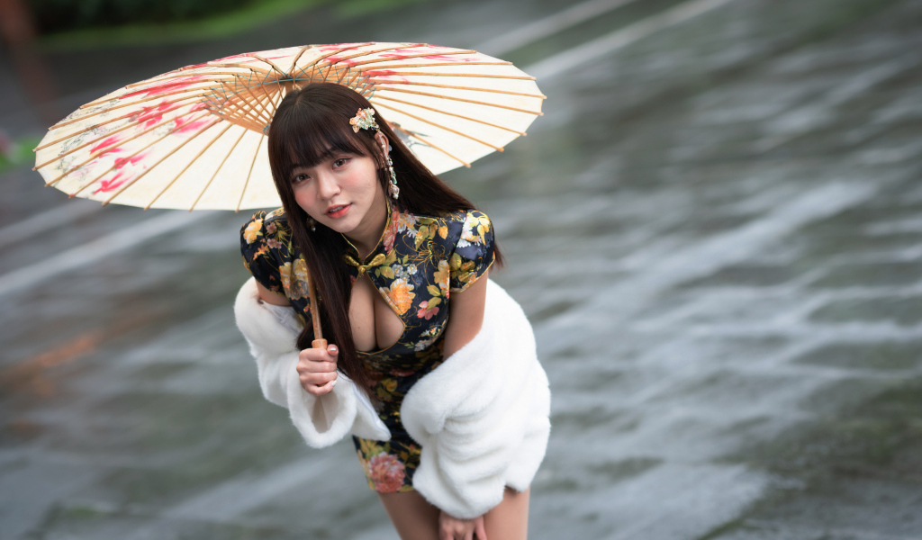 Настоящая азиатка стоит под зонтом
