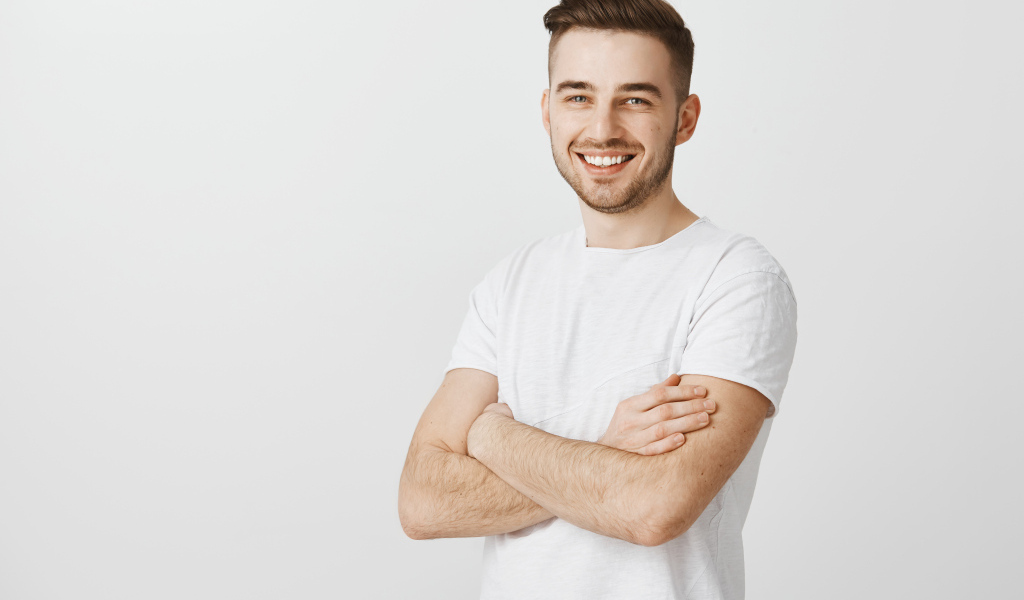 Улыбающийся молодой человек с белой футболке