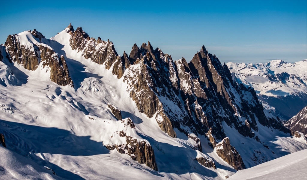 Солнце покрывает заснеженные горы
