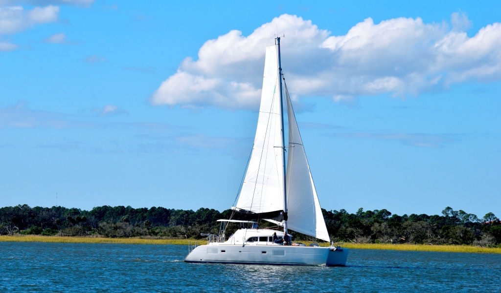 Парусная яхта в море на фоне красивого неба