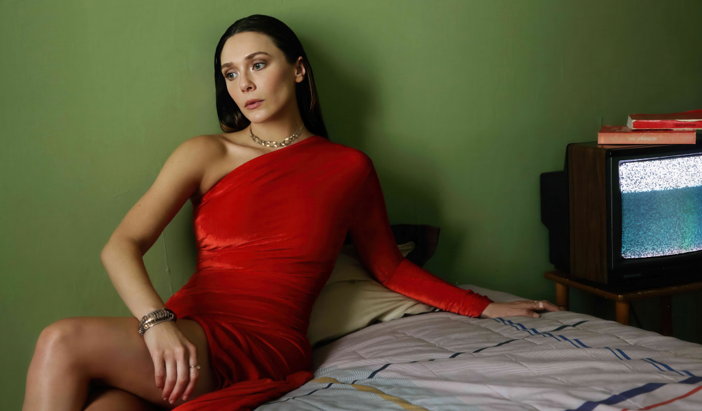 Актриса Элизабет Олсен в красном платье сидит на кровати