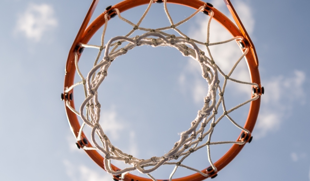 Вид снизу на баскетбольное кольцо на фоне неба