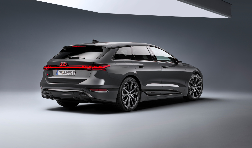 Автомобиль Audi A6 Avant e-tron S line 2024 года на сером фоне вид сзади