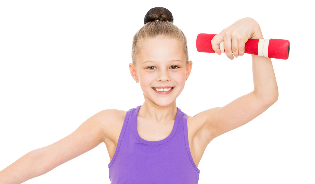 Улыбающаяся девочка гимнастка на белом фоне