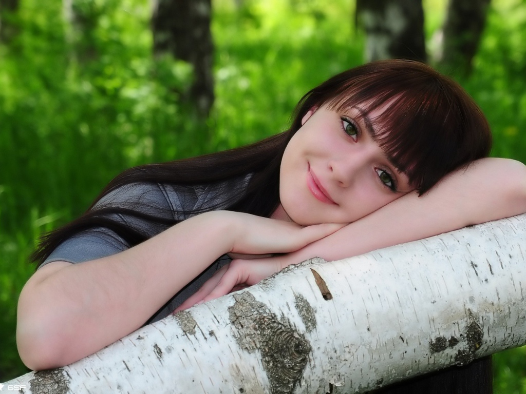 Девушка улыбается в лесу