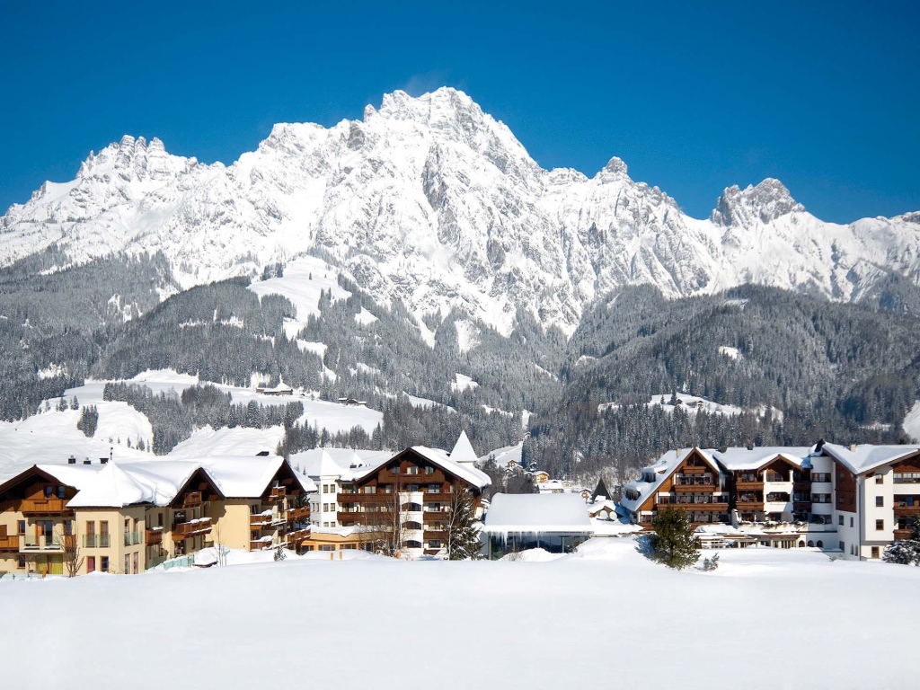 Дома на фоне гор на горнолыжном курорте Заальбах Хинтерглем, Австрия