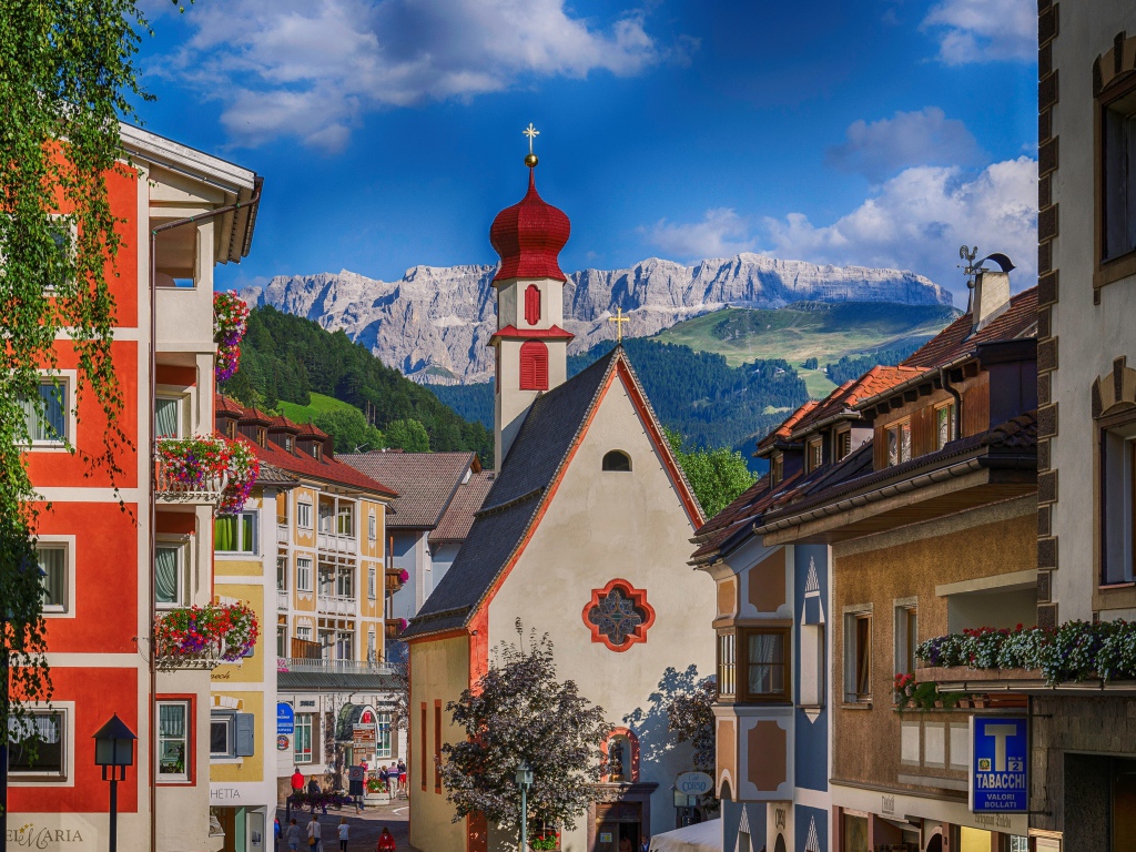 Church on a background of mountains in Ortisei, Italy