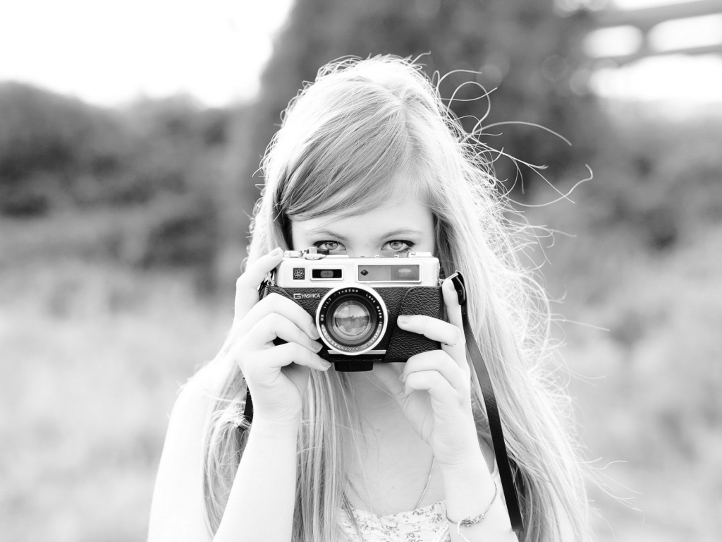 Girl with camera, black-and-white photo