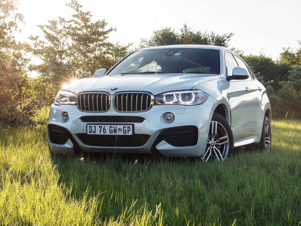 Белый BMW в поле за городом