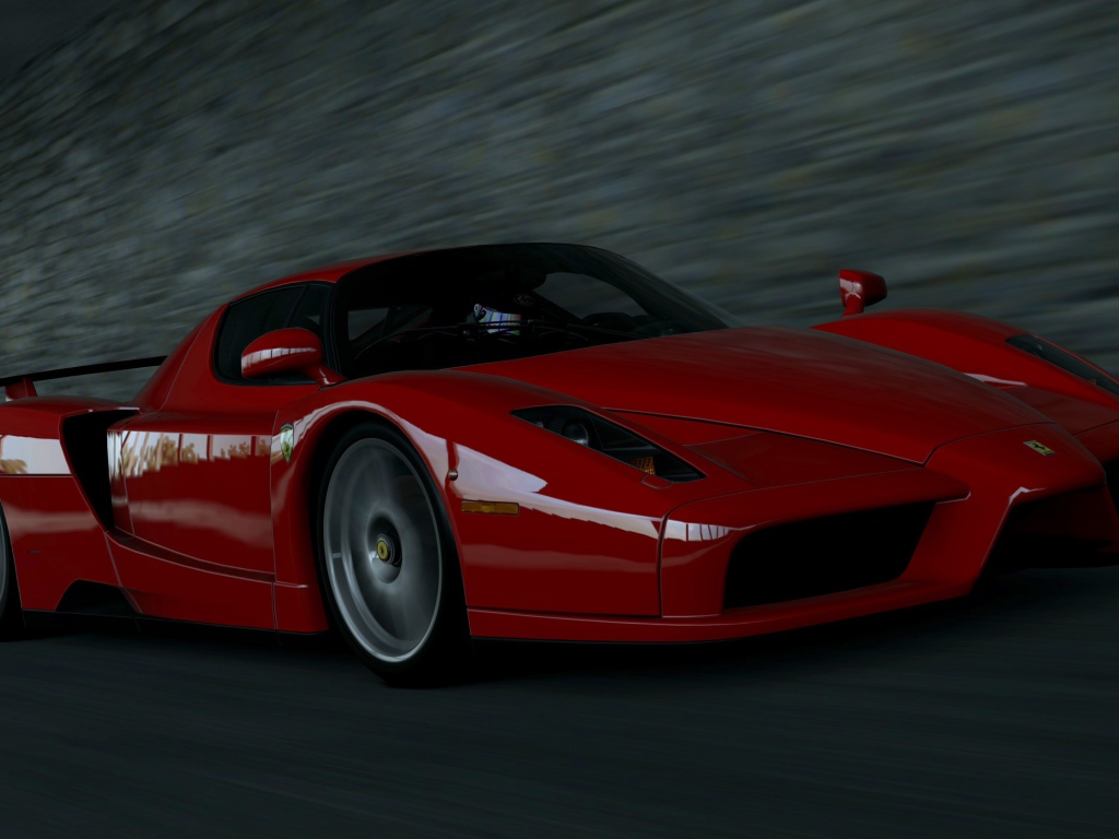 Красный Ferrari Enzo мчится на черном фоне
