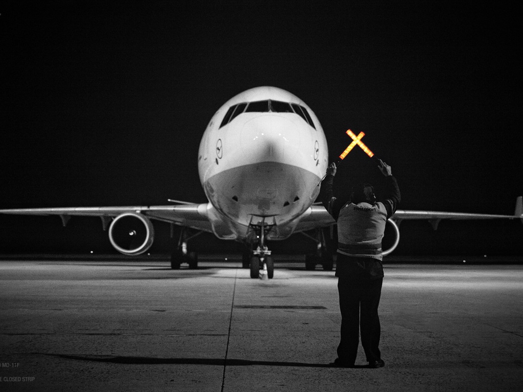 Сотрудник аэропорта помогает пилотам