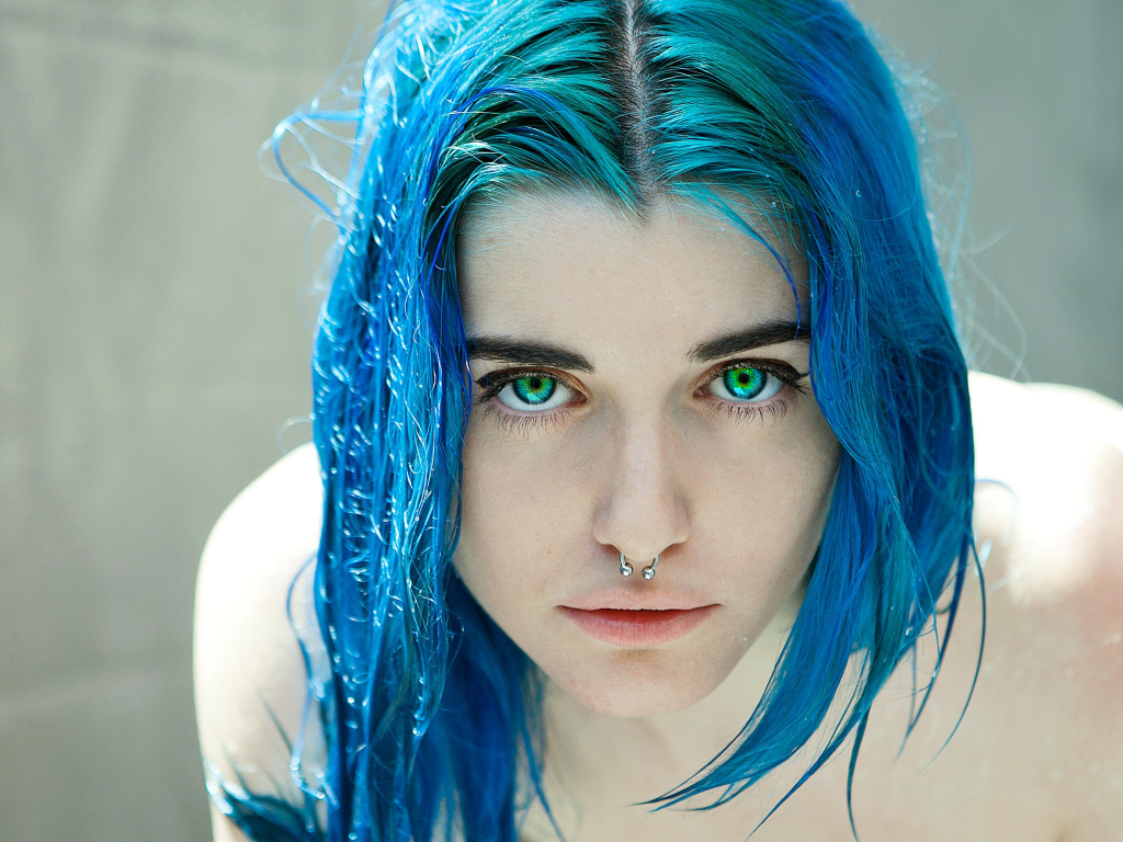 Green-eyed girl with blue hair and a nose ring