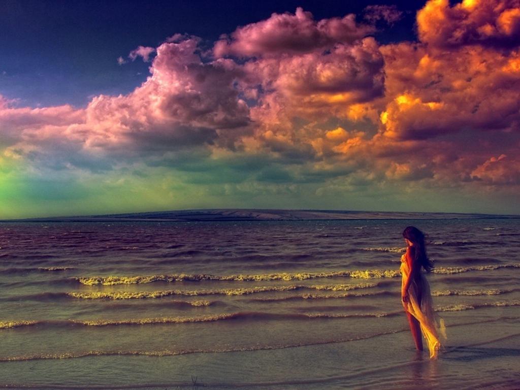 Девушка входит в волны прибоя