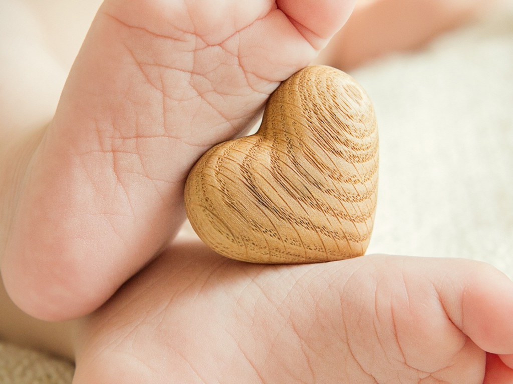 Деревянное сердце между ступней