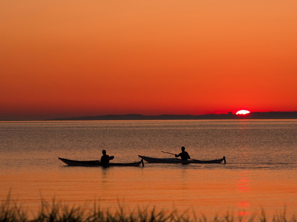 Два лодочника на фоне заката