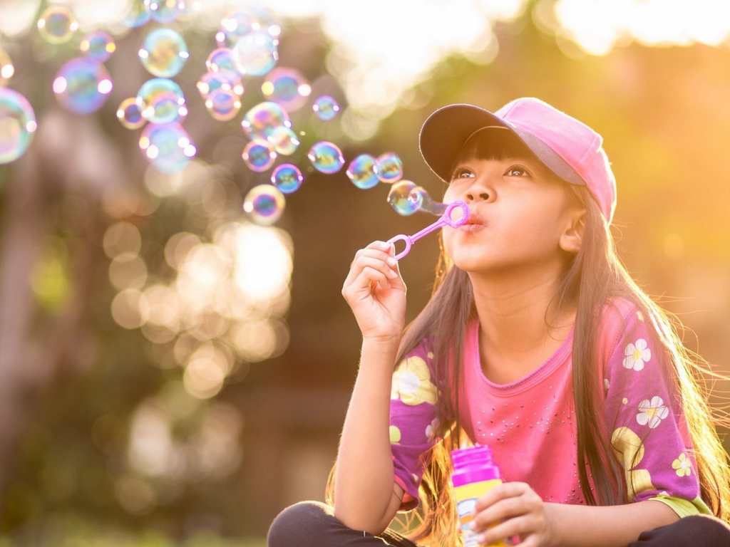 Девочка запускает мыльные пузыри