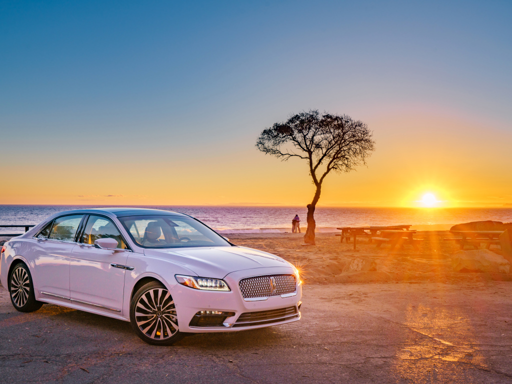White Lincoln Continental 2017 on the background of sunset
