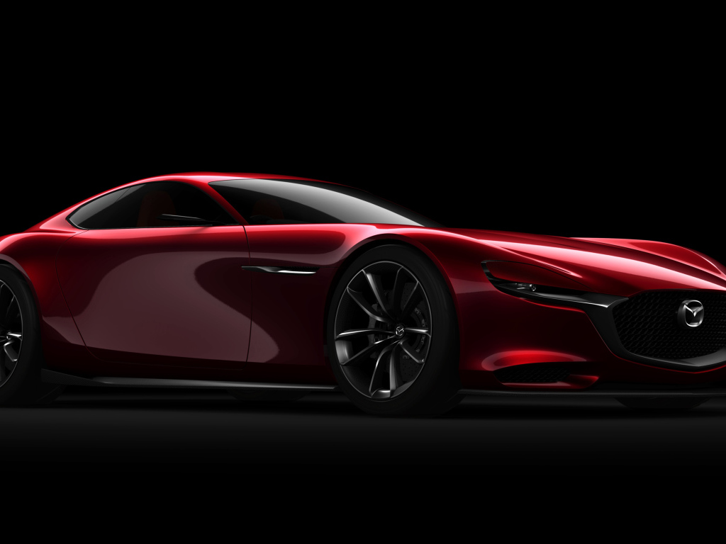 Красный спортивный автомобиль Mazda RX Vision Concept на черном фоне
