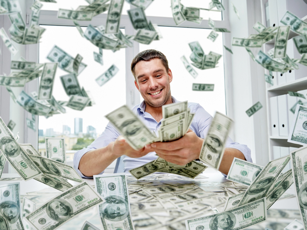 A smiling man is scattering dollars