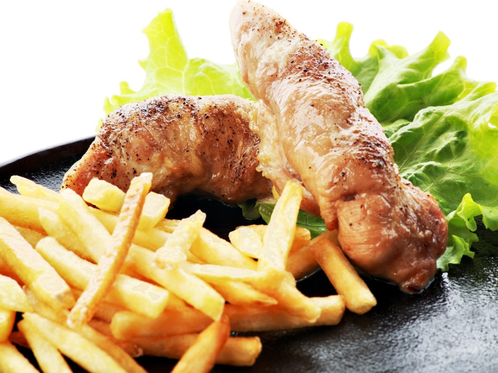 Куриные рулеты с картофелем фри и зелеными листьями салата