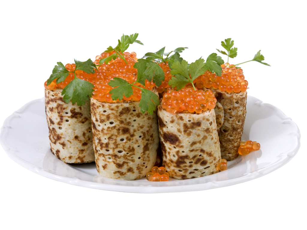 Роллы из блинов с красной икрой на белом блюде