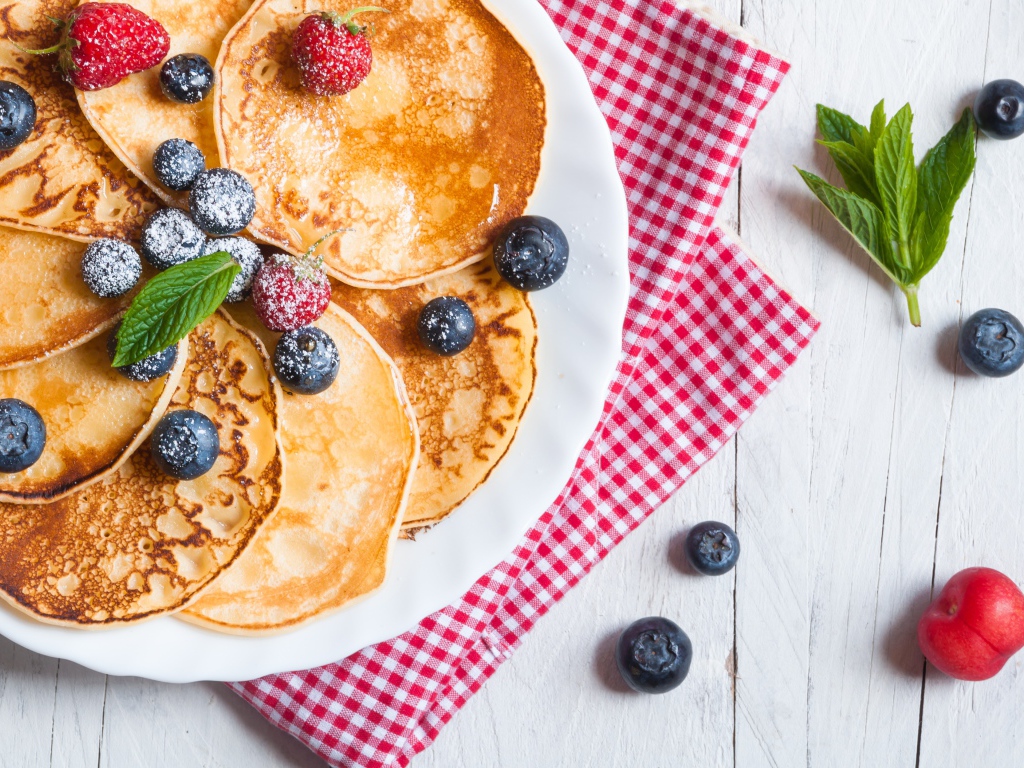 Аппетитные свежие оладьи с ягодами черники и земляники