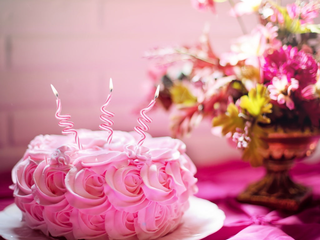 Pink cake with candles on Birthday