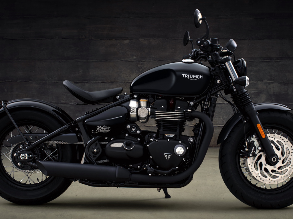 Черный мотоцикл Triumph Bonneville Bobber, 2018 вид сбоку