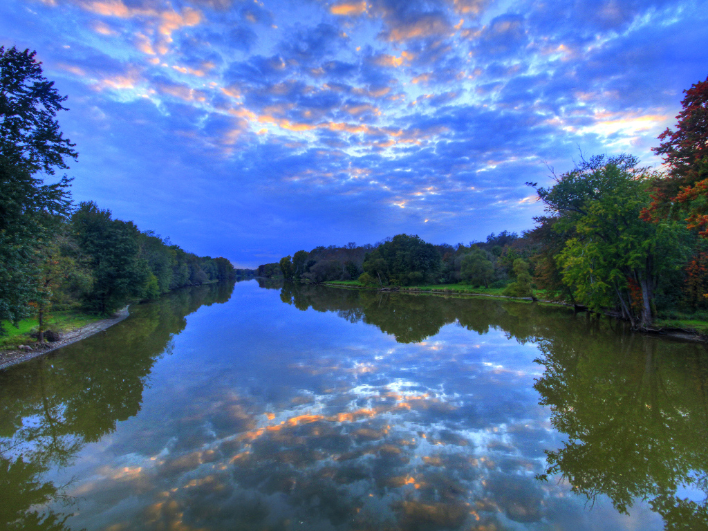 Красивое необычное небо отражается в реке