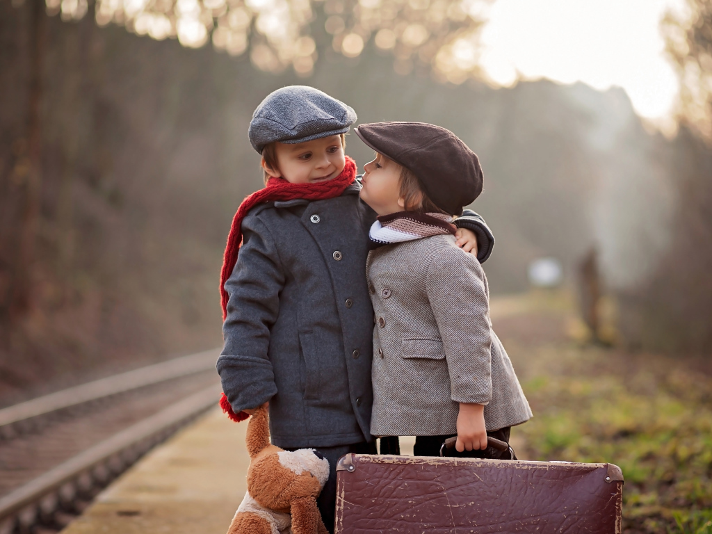 Два мальчика с большим чемоданом у железной дороги