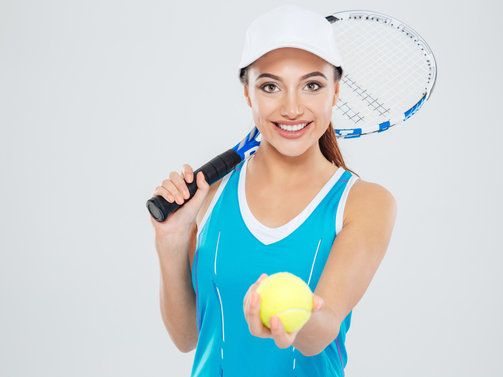 Girl sportswoman with tennis racket and ball