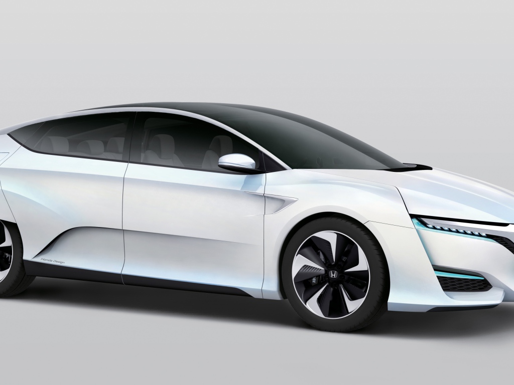 Белый электромобиль  Honda FCv на сером фоне