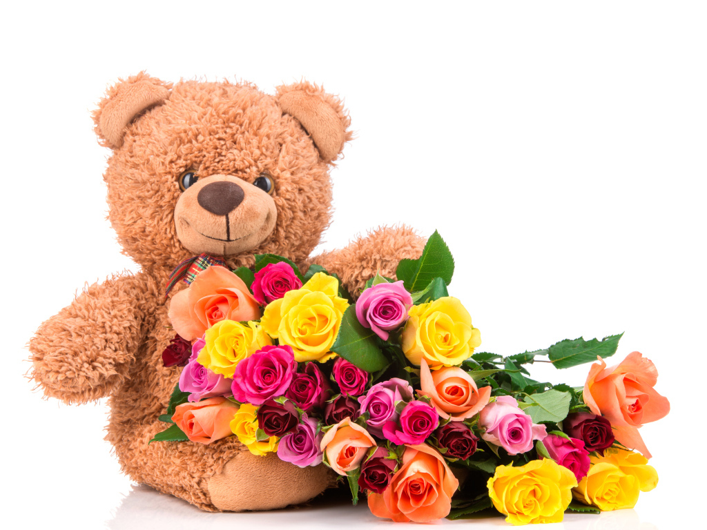 Плюшевый медведь с букетом разноцветных роз на белом фоне