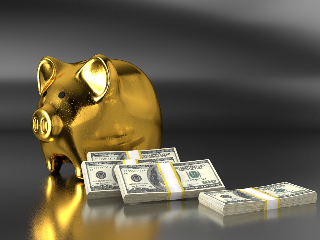 Свинья копилка на сером фоне с пачками долларов