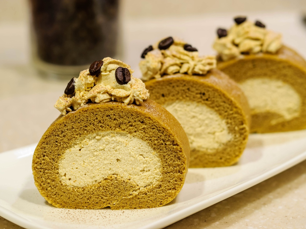 Сладкий рулет с кремом и зернами кофе